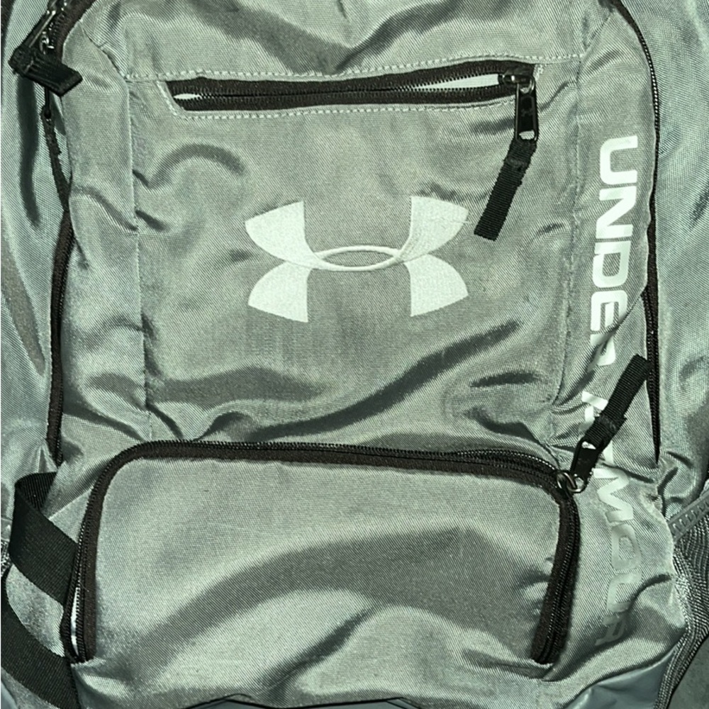 Under Armour grey back pack with black zippers and white lettering.